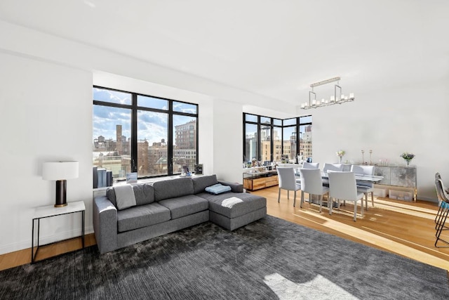 living room featuring an inviting chandelier and wood-type flooring