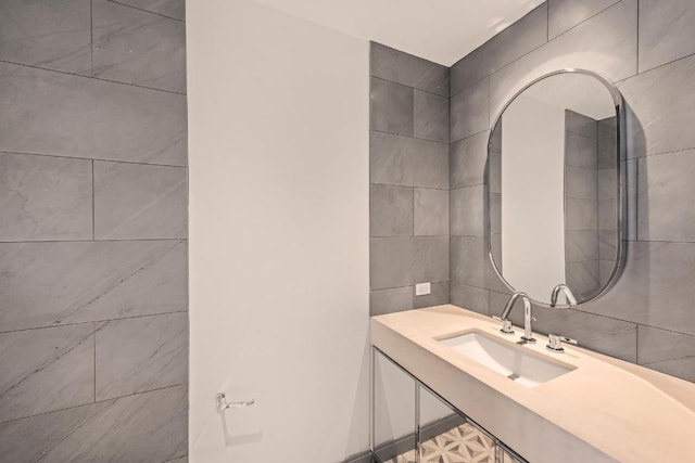 bathroom with tile walls and sink