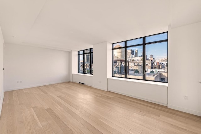 spare room featuring light hardwood / wood-style flooring