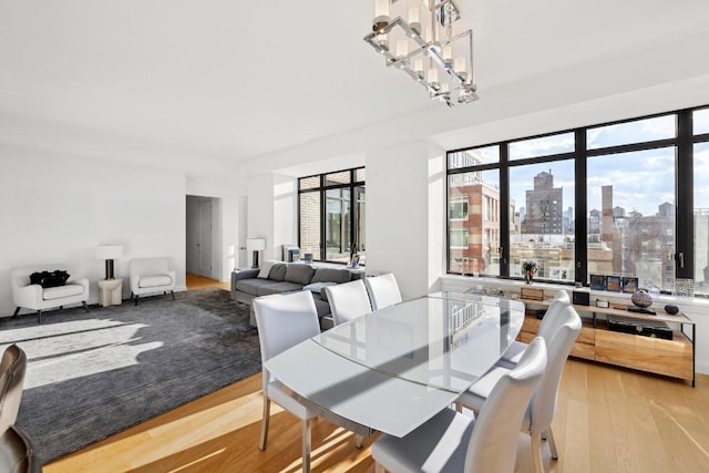 dining room with a chandelier and light hardwood / wood-style floors