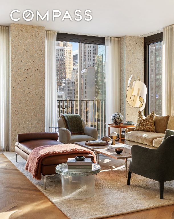 living area with parquet flooring and a wall of windows