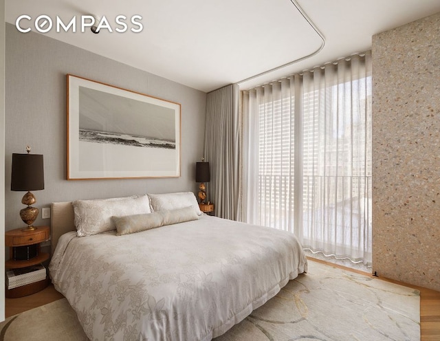 bedroom with wood-type flooring