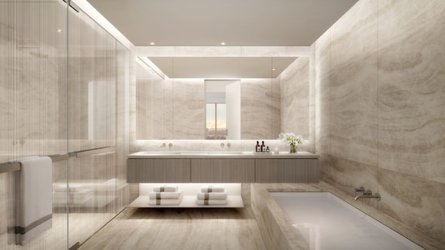 bathroom featuring vanity and tile walls