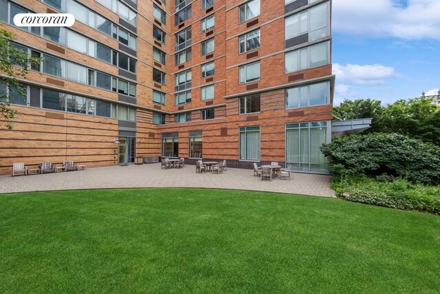 425 Main St Unit 16B, New York City, NY 10044 - exterior space with a patio area and a lawn