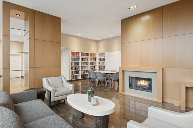 living room featuring wood finished floors and a glass covered fireplace