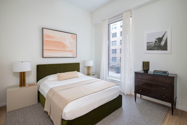 bedroom with hardwood / wood-style flooring