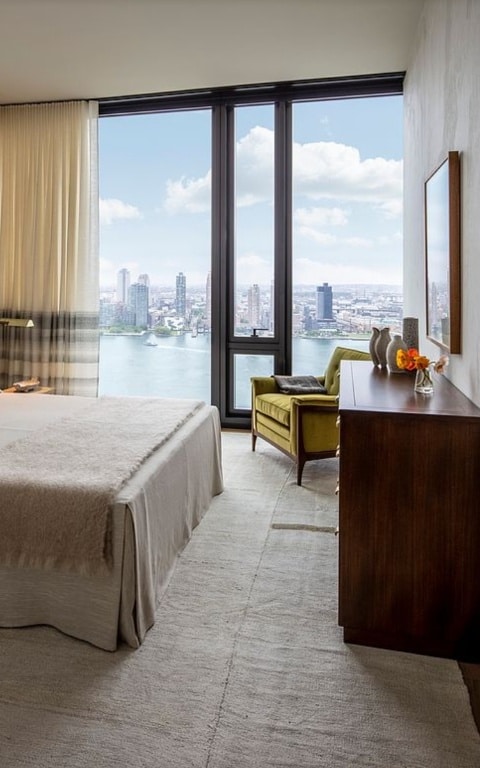 bedroom featuring multiple windows and a water view