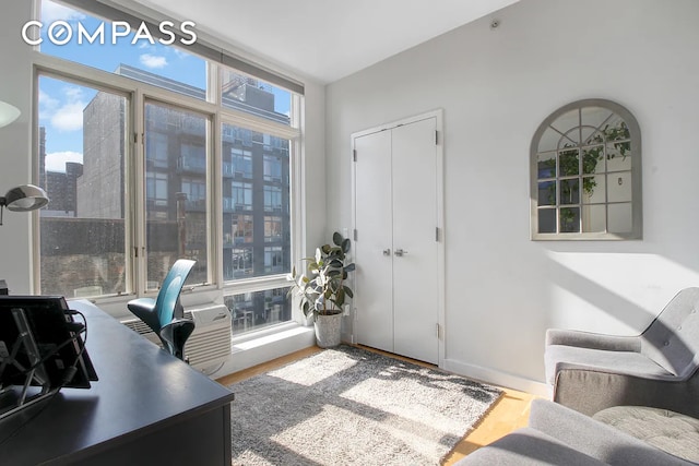 office space with baseboards and wood finished floors