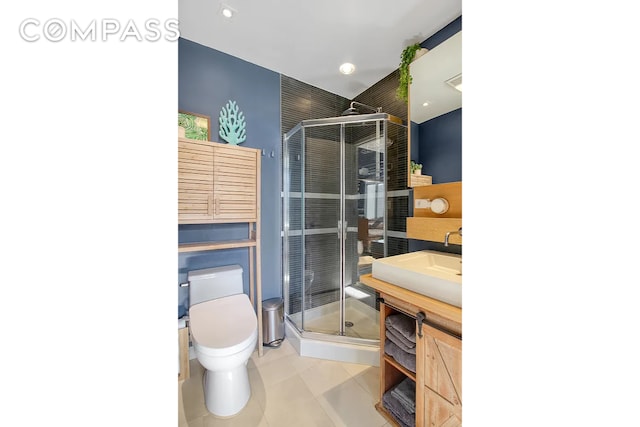 bathroom featuring toilet, recessed lighting, a shower stall, tile patterned flooring, and vanity