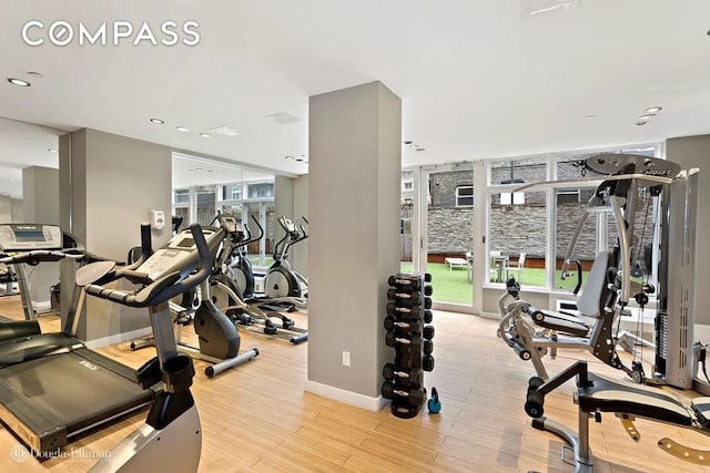 workout area with a wealth of natural light, recessed lighting, baseboards, and light wood finished floors