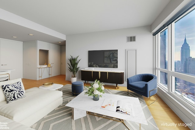 living room featuring light wood finished floors and visible vents