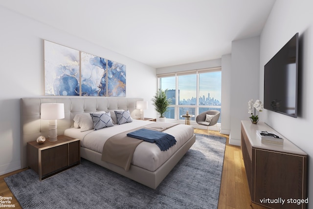 bedroom featuring wood finished floors and baseboards