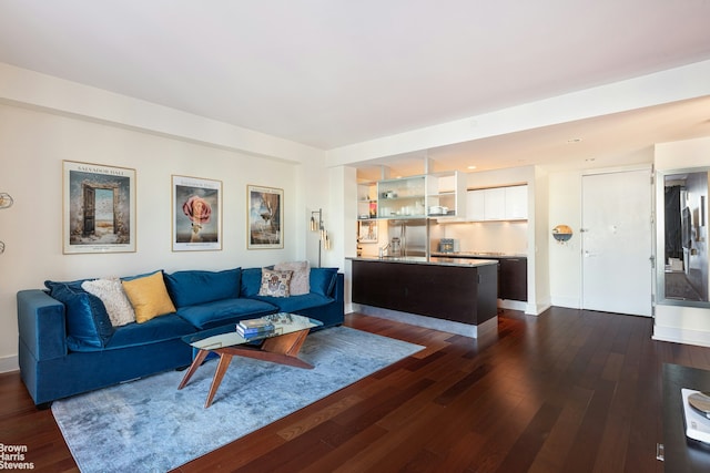 living area featuring baseboards and dark wood-style flooring