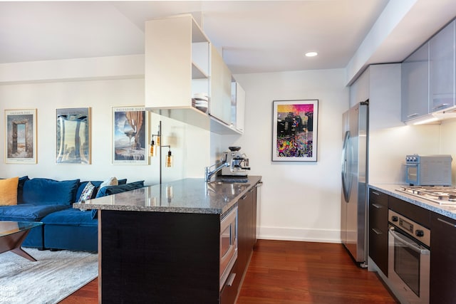350 W 42nd St Unit 53F, New York City, NY 10036 - kitchen with appliances with stainless steel finishes, dark wood-style floors, light stone countertops, baseboards, and recessed lighting