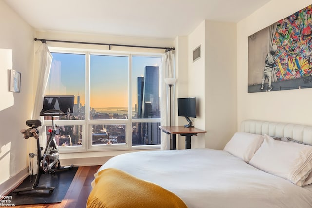 bedroom featuring visible vents and wood finished floors