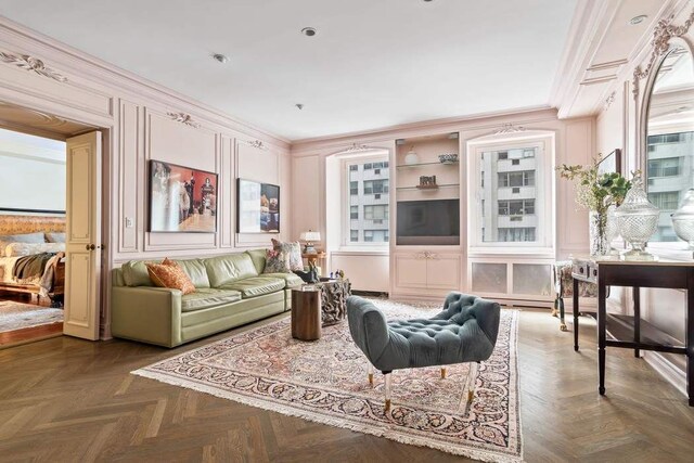 dining space featuring ornamental molding and light parquet floors