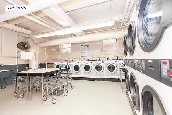 shared laundry area with stacked washer and dryer, washing machine and dryer, and visible vents