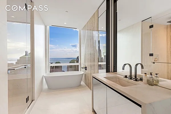 111 Murray St Unit 44W, New York City, NY 10007 - bathroom with vanity, a freestanding bath, a stall shower, tile patterned floors, and expansive windows