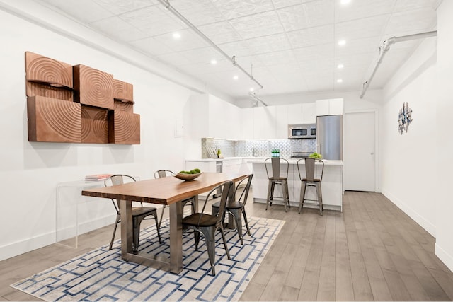 dining area featuring recessed lighting, light wood-style flooring, and baseboards