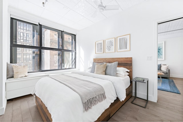 131 W 28th St Unit 3A, New York City, NY 10001 - bedroom with multiple windows, wood finished floors, and ceiling fan