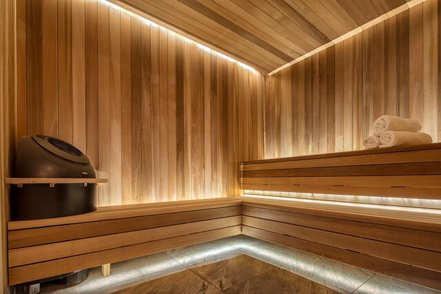 kitchen with sink, a kitchen island, light parquet flooring, and a kitchen bar