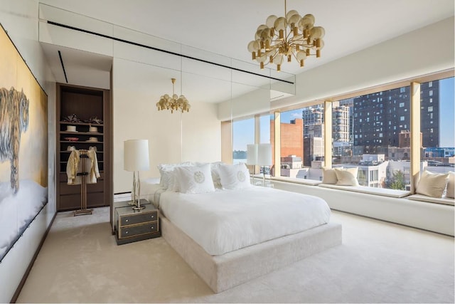 bedroom featuring a chandelier and carpet