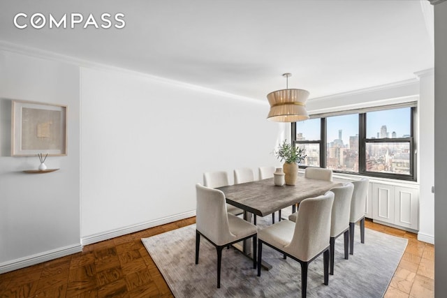 dining space featuring crown molding and parquet flooring