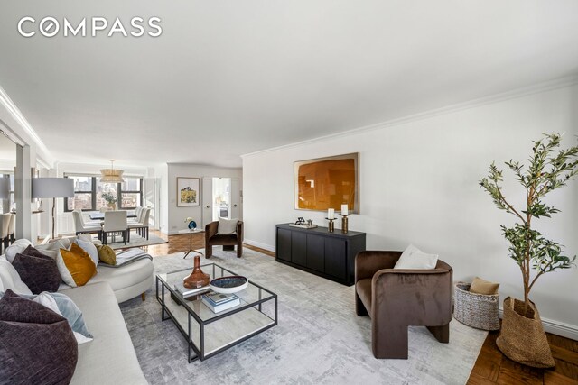 living room with crown molding and parquet floors