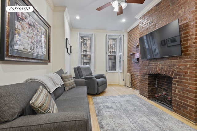 living area featuring recessed lighting, wood finished floors, ornamental molding, and a ceiling fan