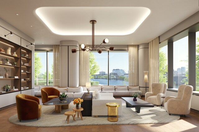 bedroom featuring expansive windows, a water view, and hardwood / wood-style floors