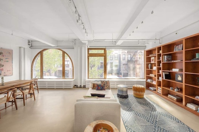 interior space with concrete flooring and rail lighting