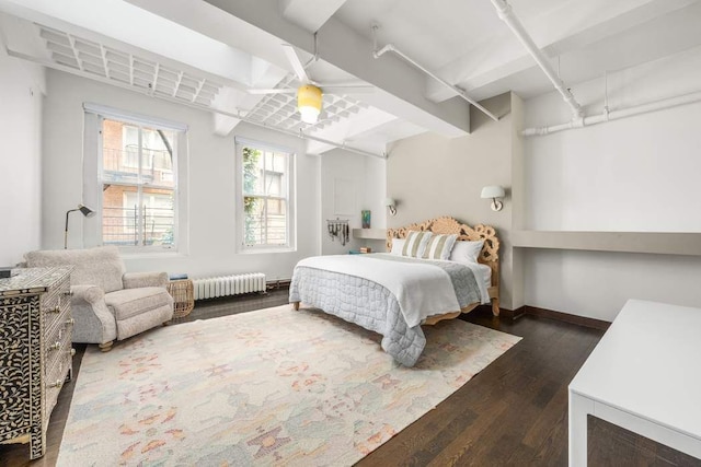 bedroom with dark wood-type flooring and radiator heating unit