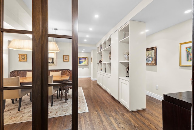 hall with recessed lighting, dark wood-style flooring, and baseboards