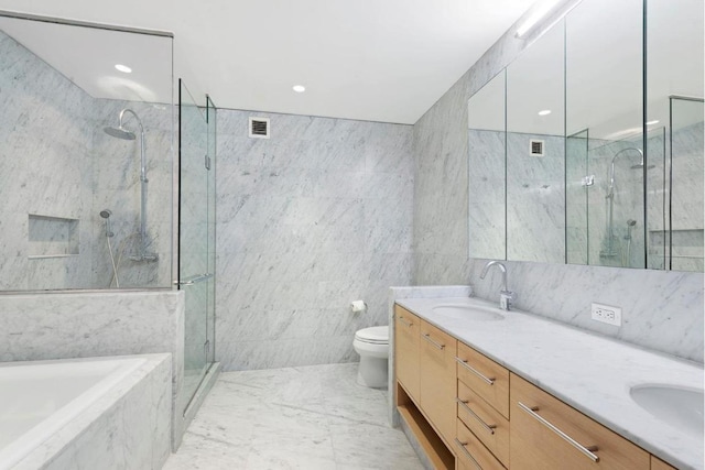 full bathroom featuring vanity, toilet, independent shower and bath, and tile walls