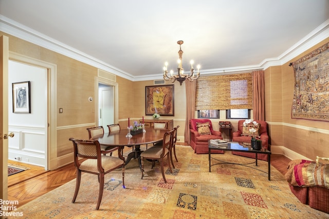 dining area with crown molding, wood-type flooring, and a notable chandelier