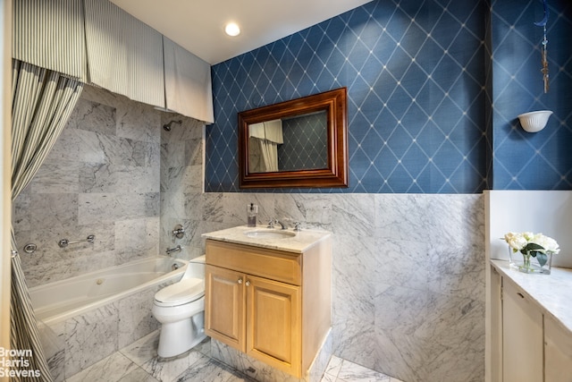 bathroom featuring vanity, toilet, and tile walls