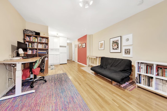 office with light wood-style flooring and baseboards