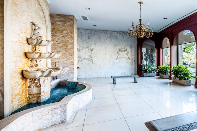 interior space featuring visible vents, tile patterned flooring, and a notable chandelier