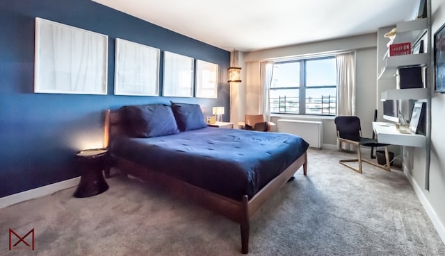 carpeted bedroom with radiator heating unit and baseboards