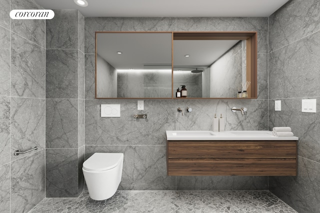 bathroom featuring toilet, tile walls, and vanity