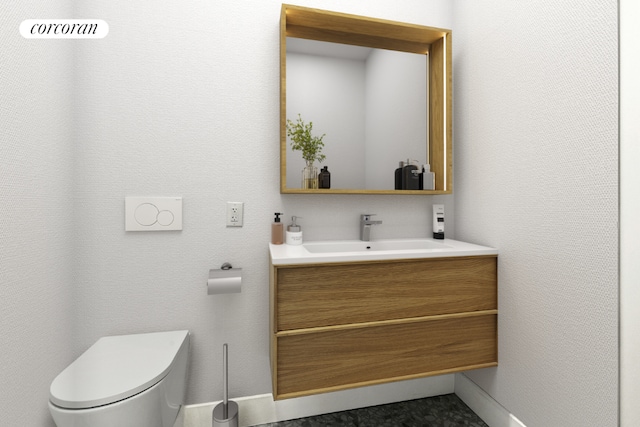 bathroom with vanity and toilet