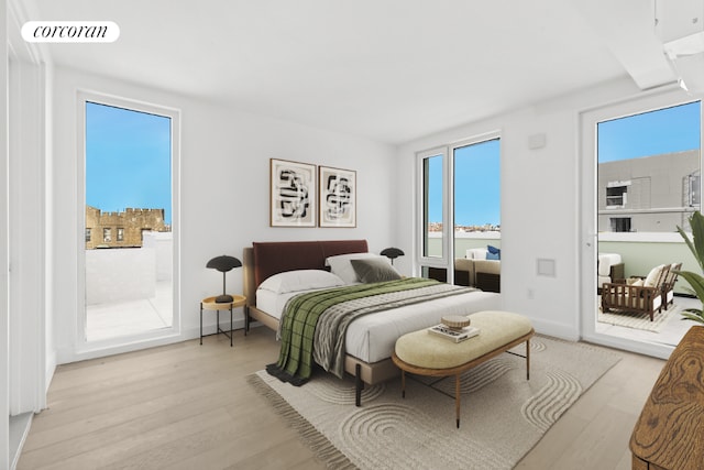 bedroom featuring light wood-type flooring and access to outside