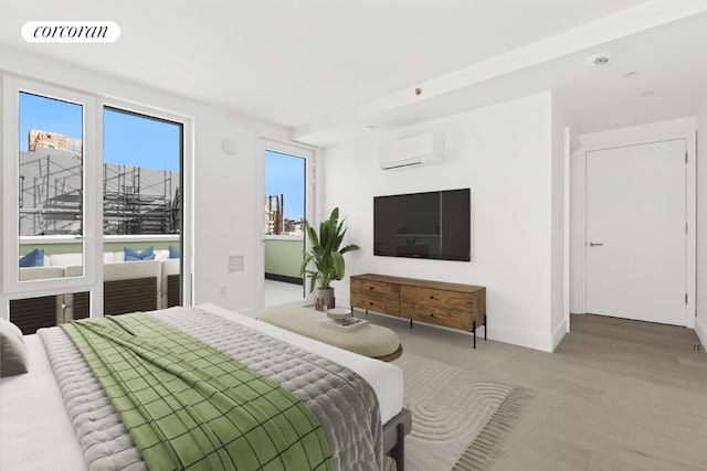 bedroom with hardwood / wood-style floors and a wall unit AC