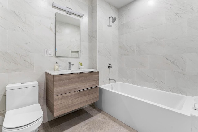 full bathroom featuring tiled shower / bath combo, vanity, tile walls, and toilet