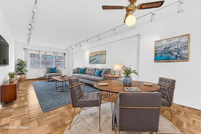 living room with rail lighting, parquet floors, and ceiling fan