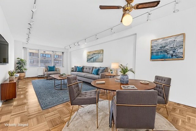 living room with ceiling fan and track lighting