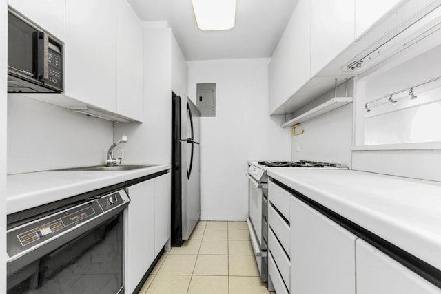 kitchen featuring sink, black appliances, light tile patterned floors, electric panel, and white cabinets