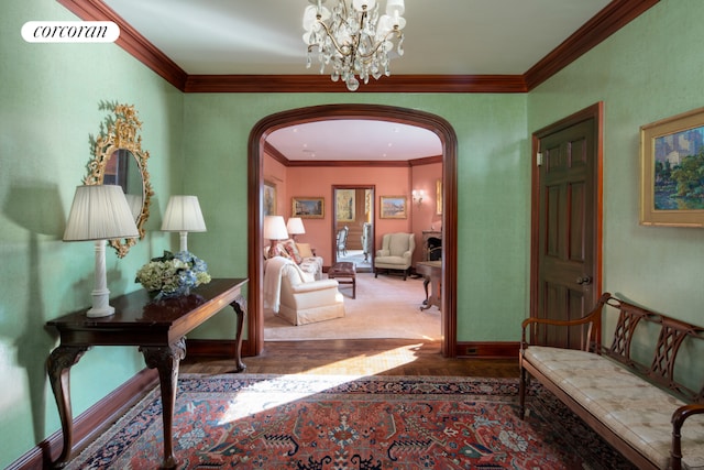 hall with crown molding and an inviting chandelier