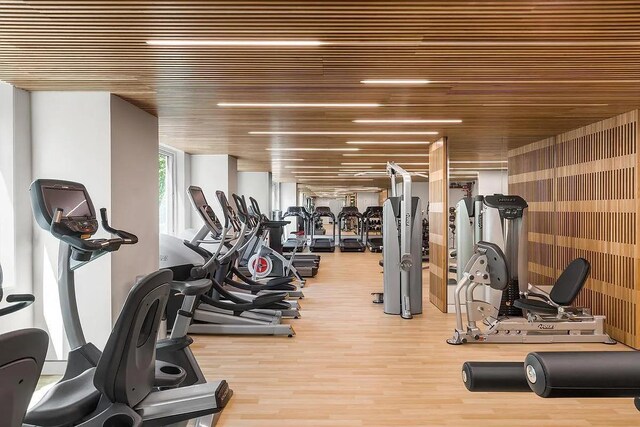 gym featuring hardwood / wood-style flooring and wood ceiling