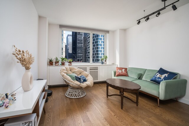 living area featuring hardwood / wood-style floors and track lighting